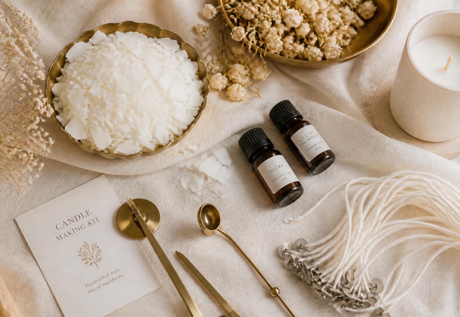 Soy wax, cotton wicks, fragrance oils and brass tools on cream linen